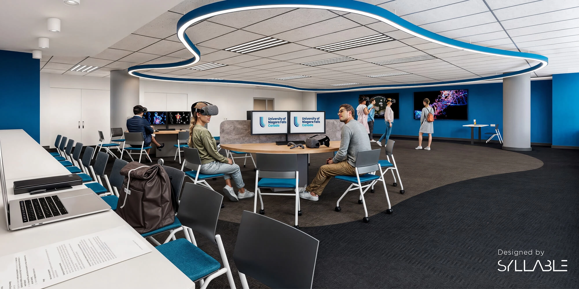 A group of individuals with VR headset in front of computers inside a UNFC facility