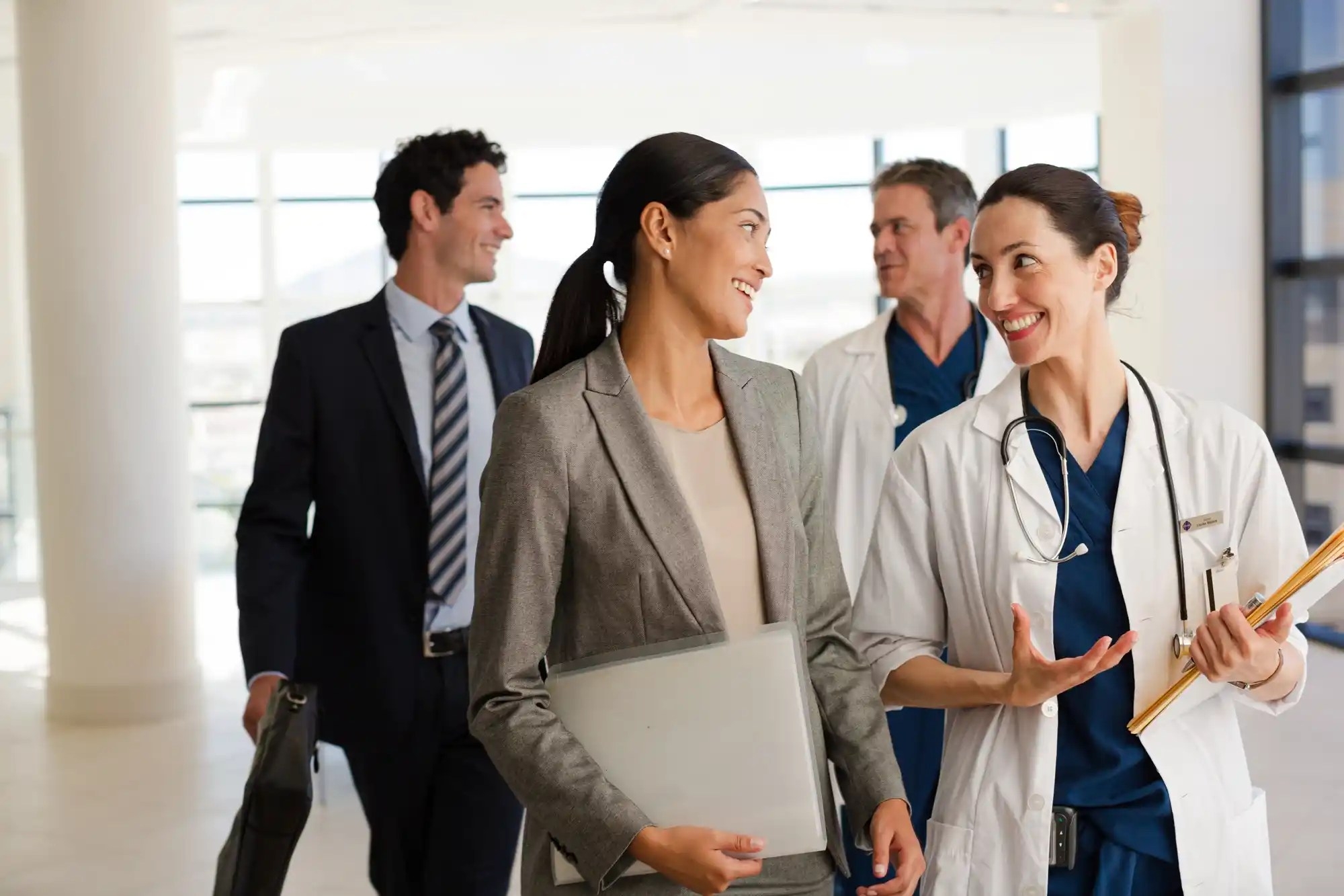 doctor and medical professionals having chat and smiling