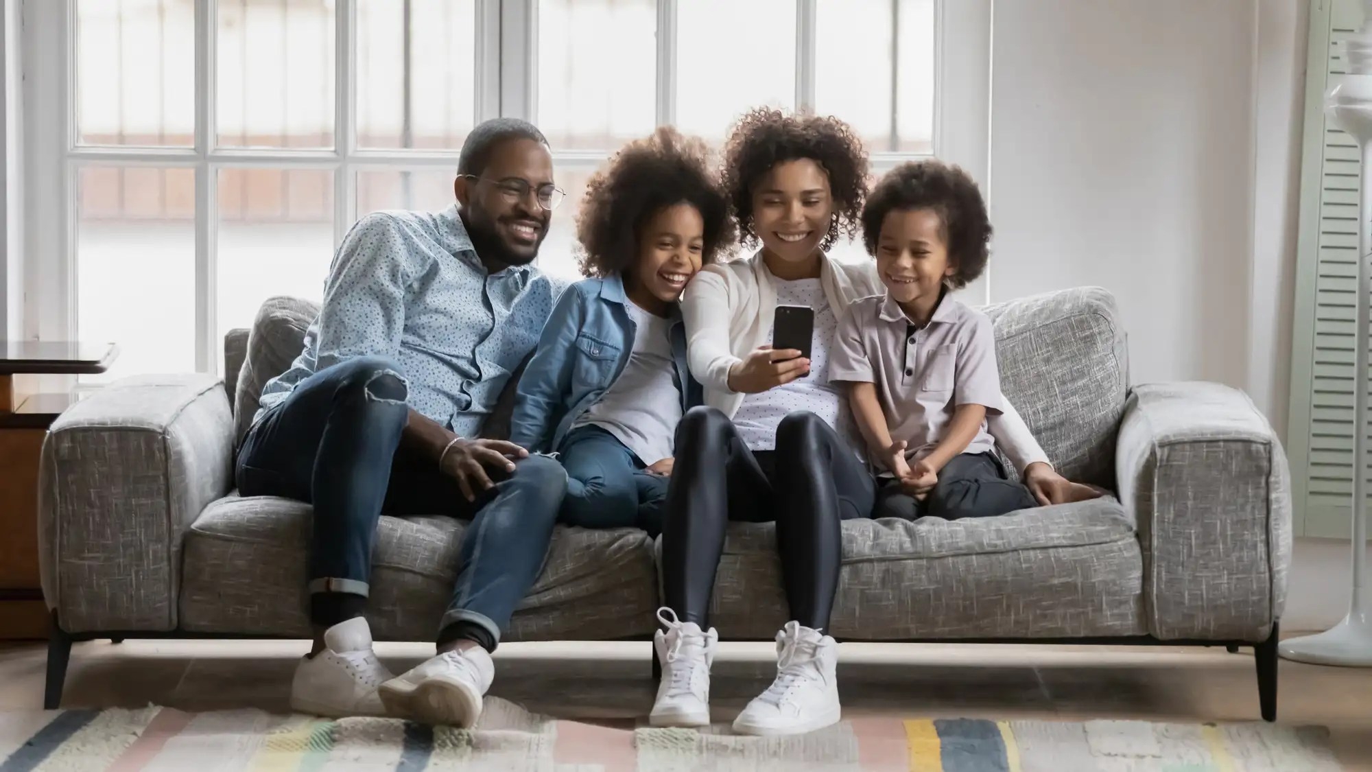 A small family doing a facetime call on a mobile phone