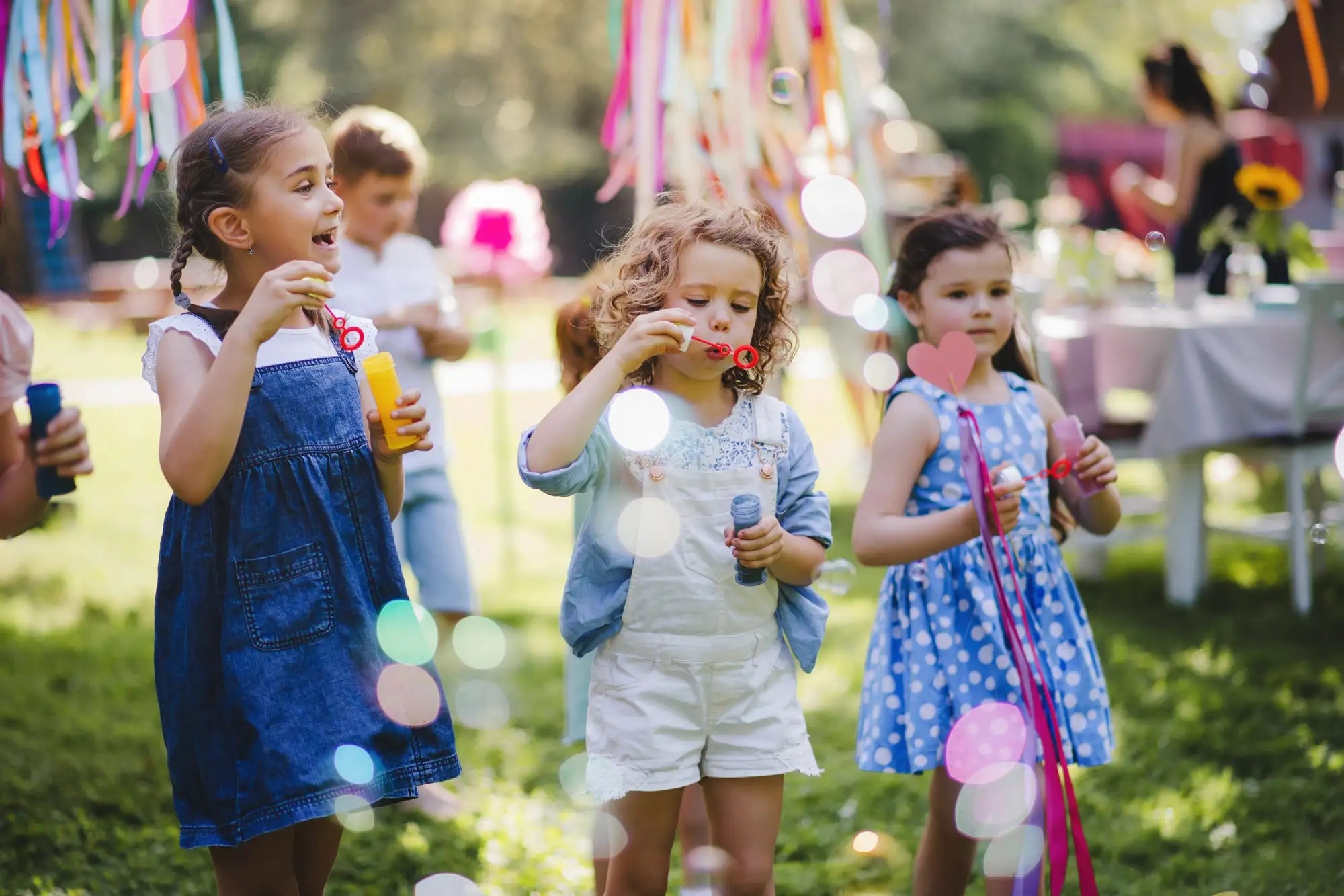 Kids playing with bubbles in outdoor setting