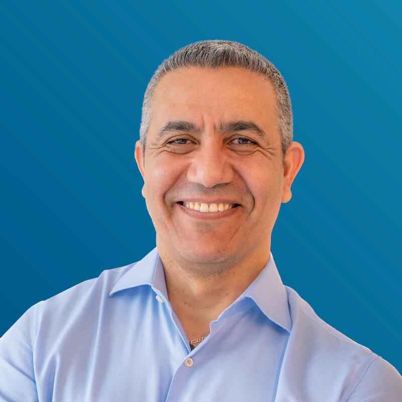 A portrait of Karim Souidi smiling