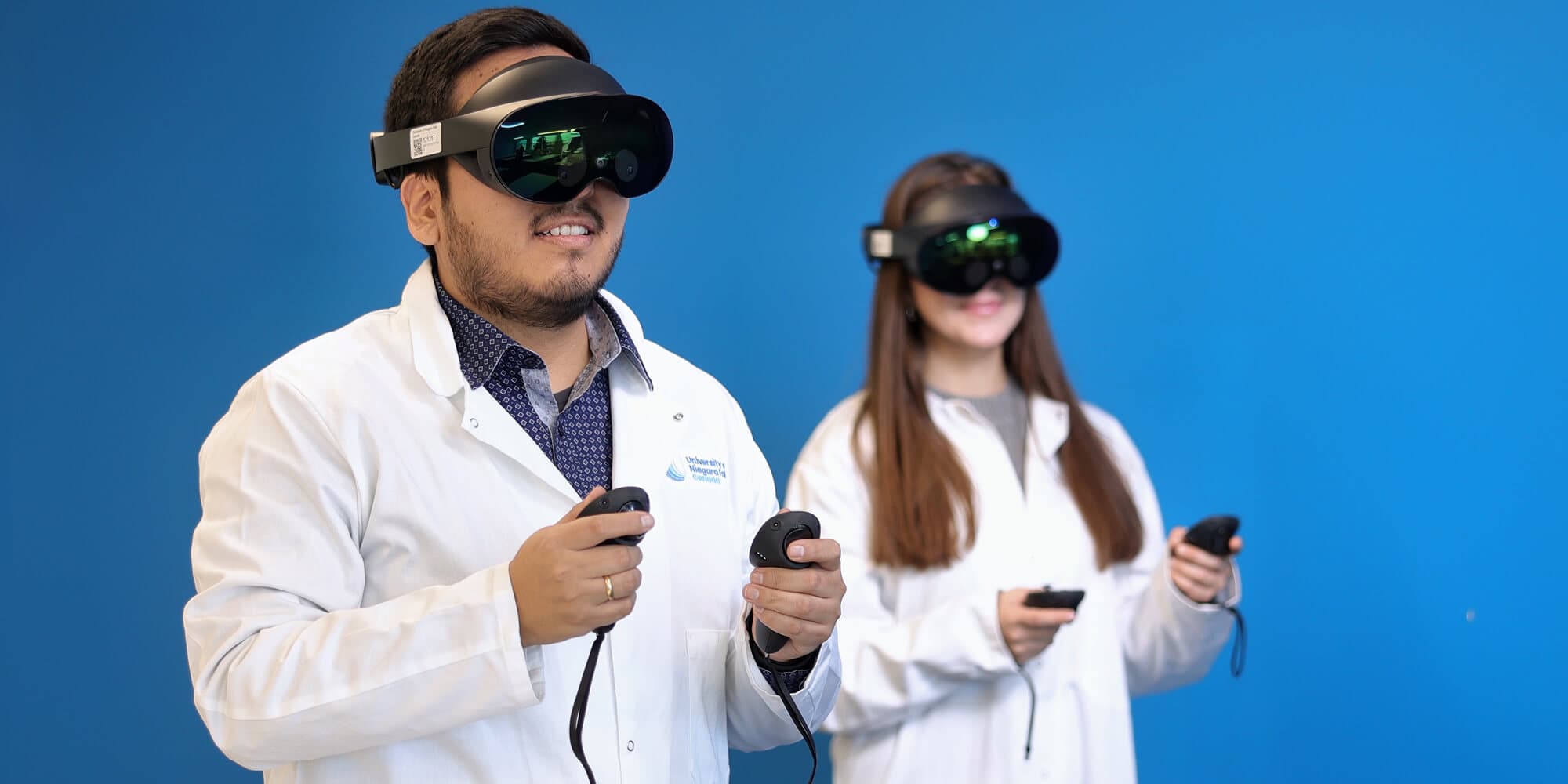 Two individuals engaged in virtual reality, wearing VR glasses and holding controllers, immersed in a digital experience