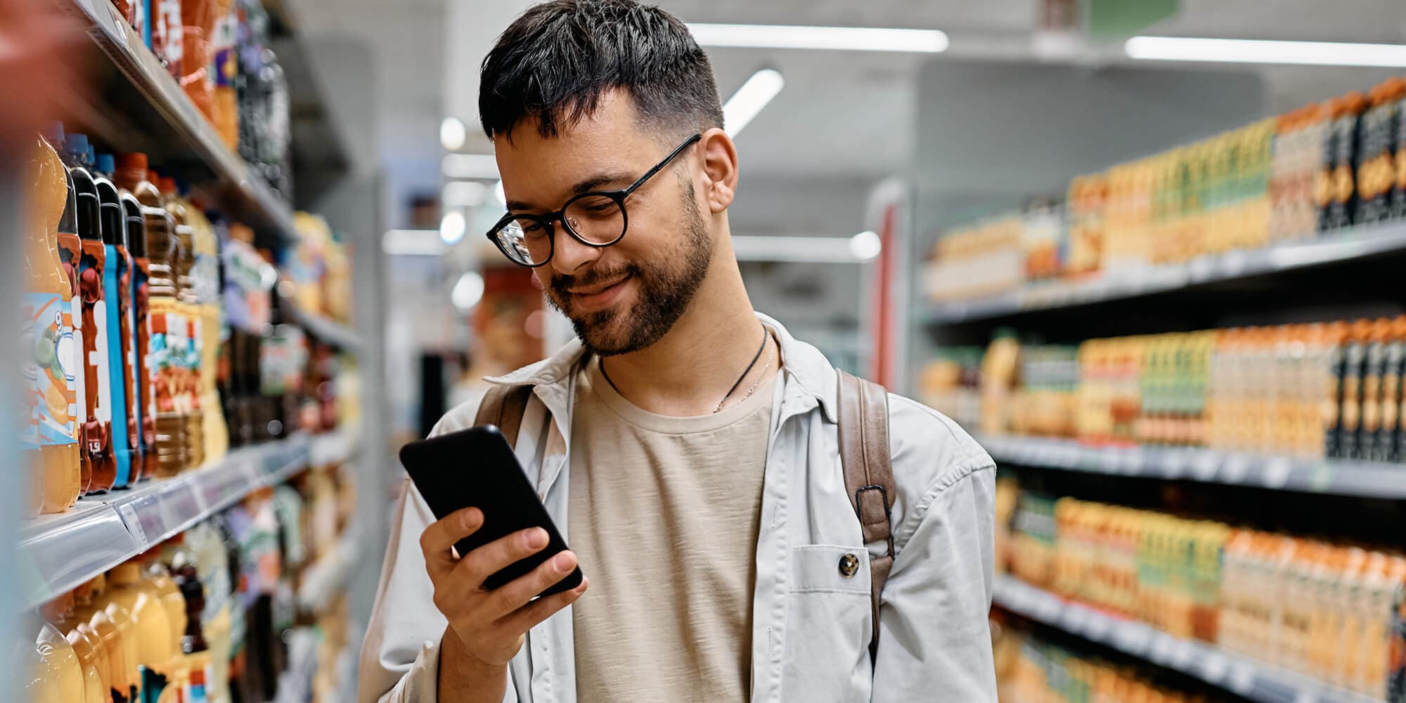A man using his cellphone on a grocery