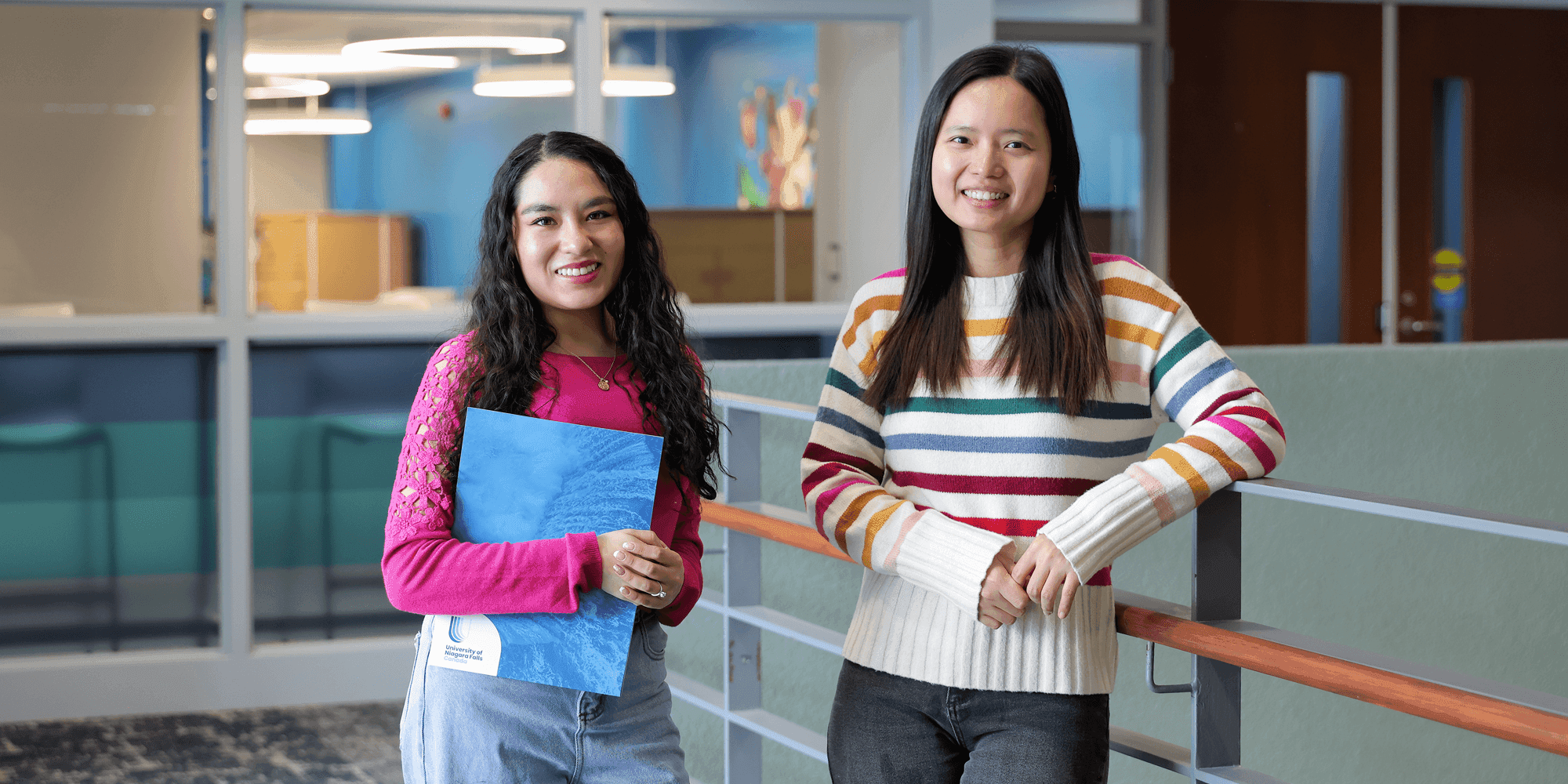 two female students smiling at the camera inside UNF campus