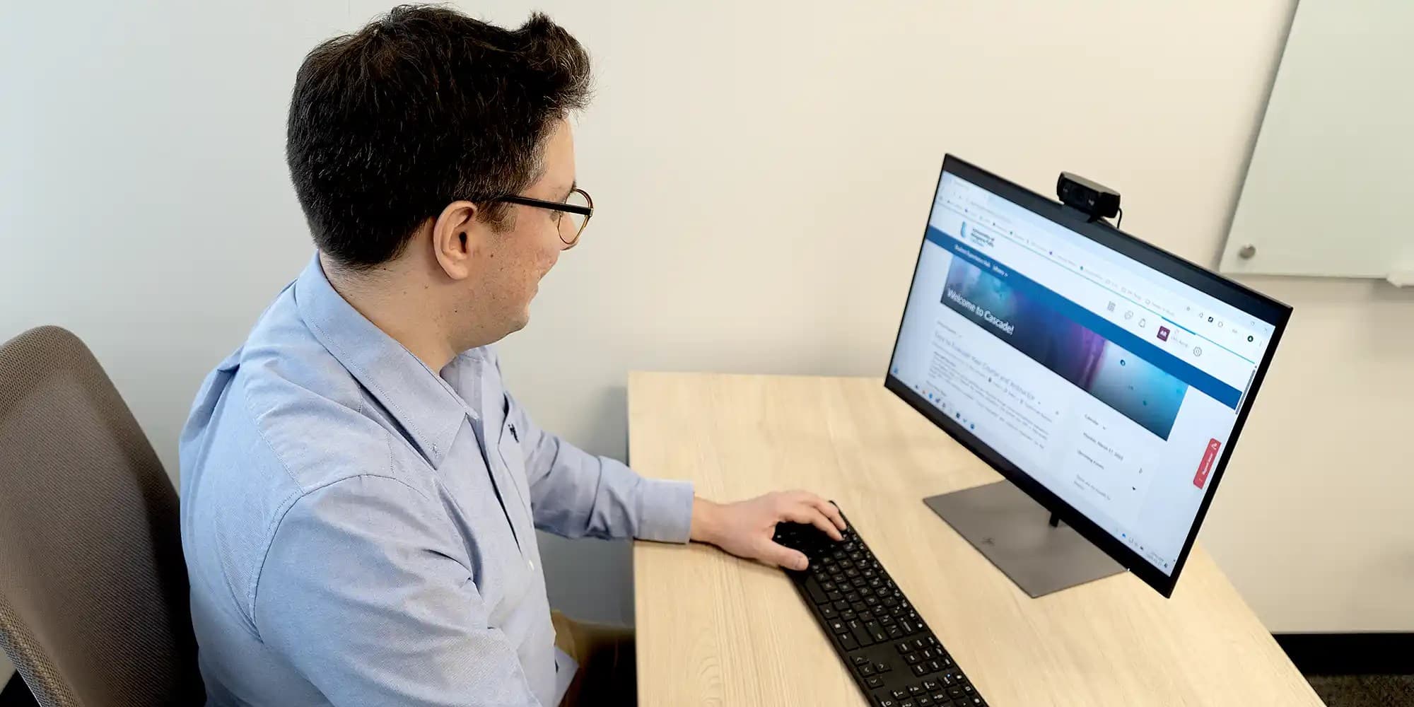 Faculty working on a computer