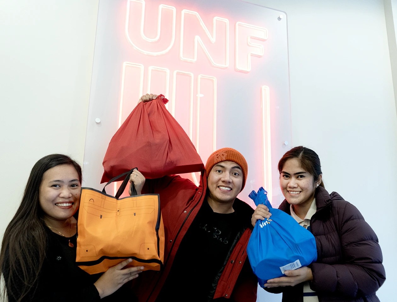 UNF students showing the food items they received