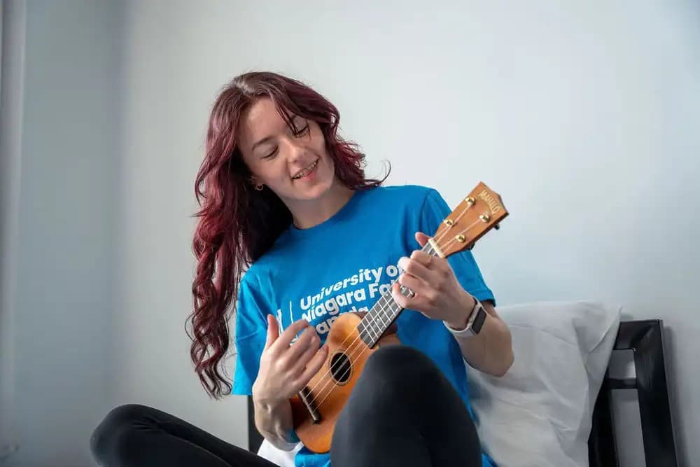 A woman playing a guitar