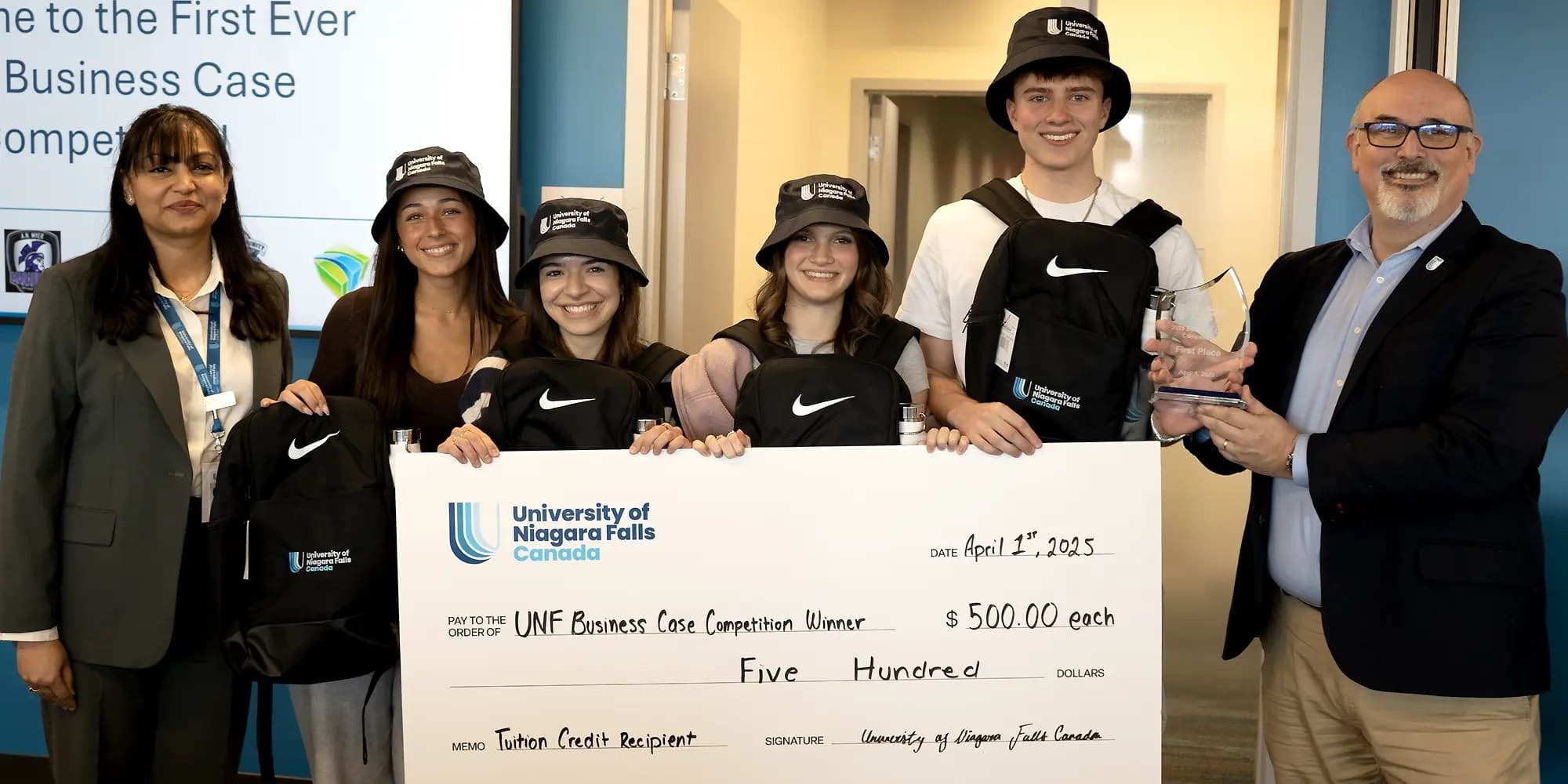 Winning UNF students holding a cheque certificate