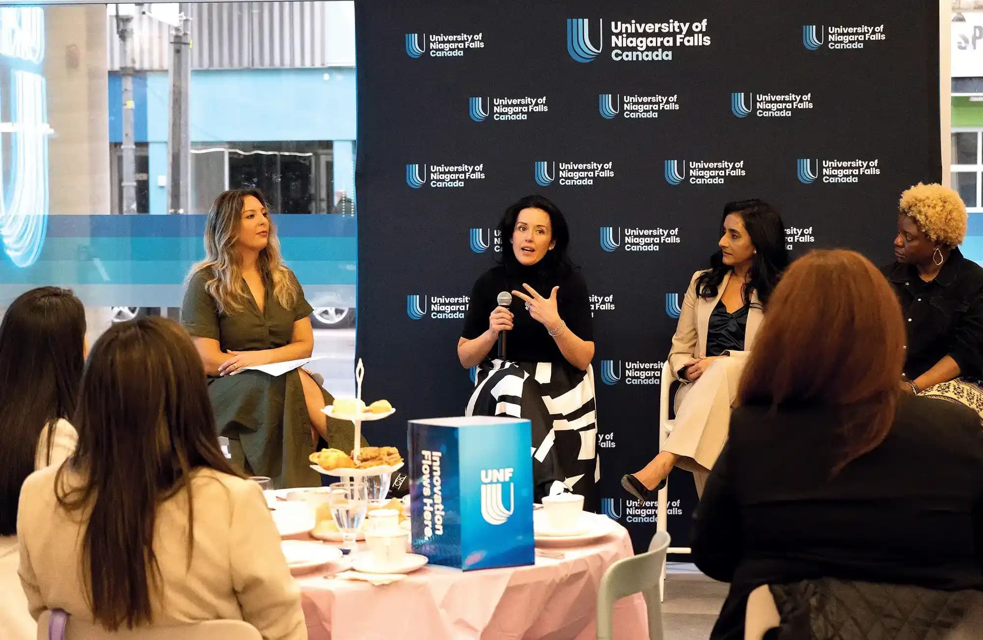 Group of women at a fair doing talk and discussion with UNF students