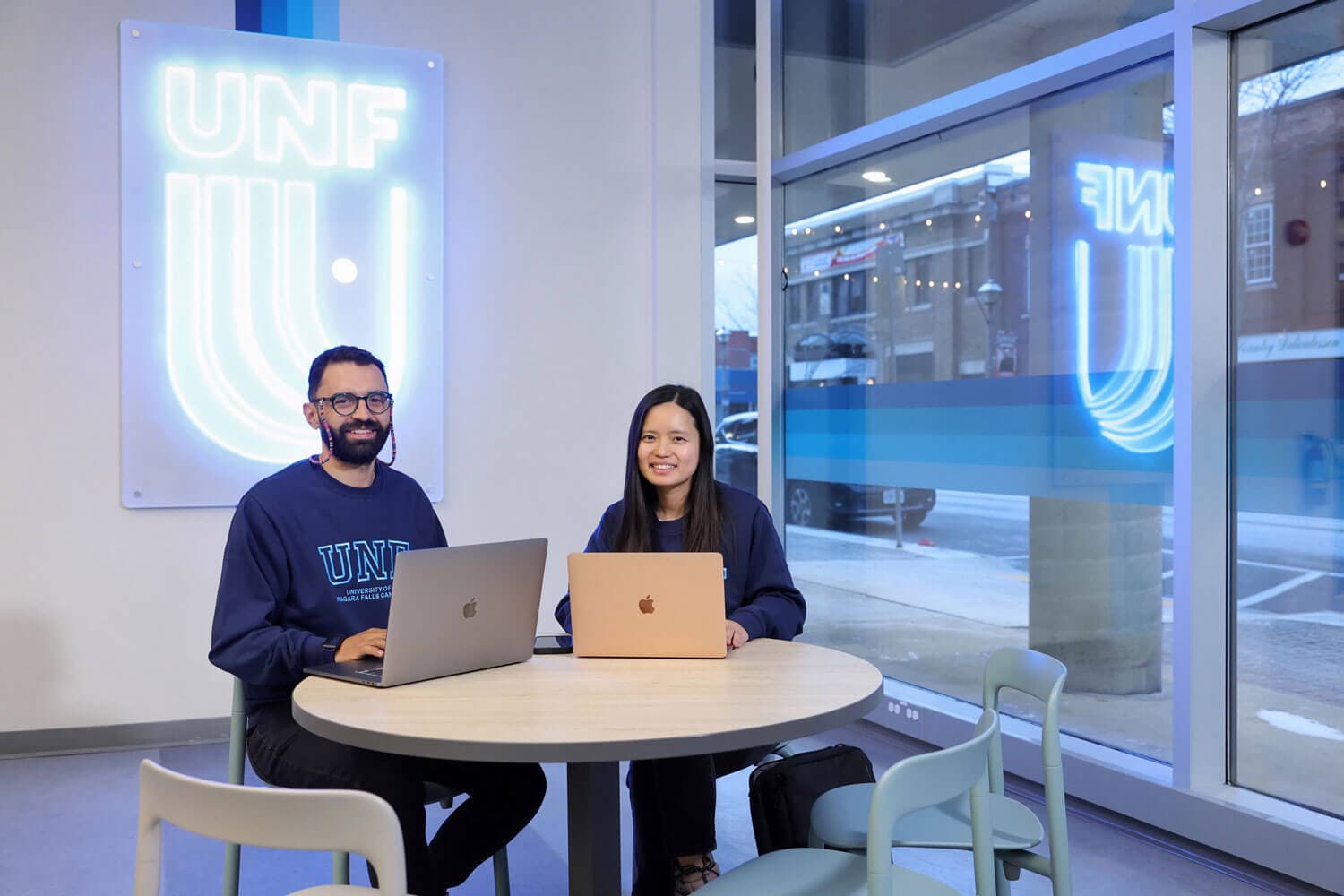 Two UNF students working on laptop
