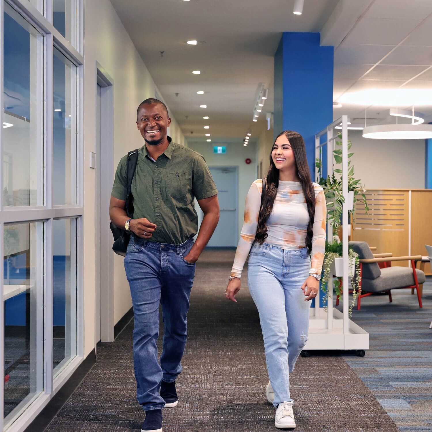 Two UNF students walking in Campus lounge