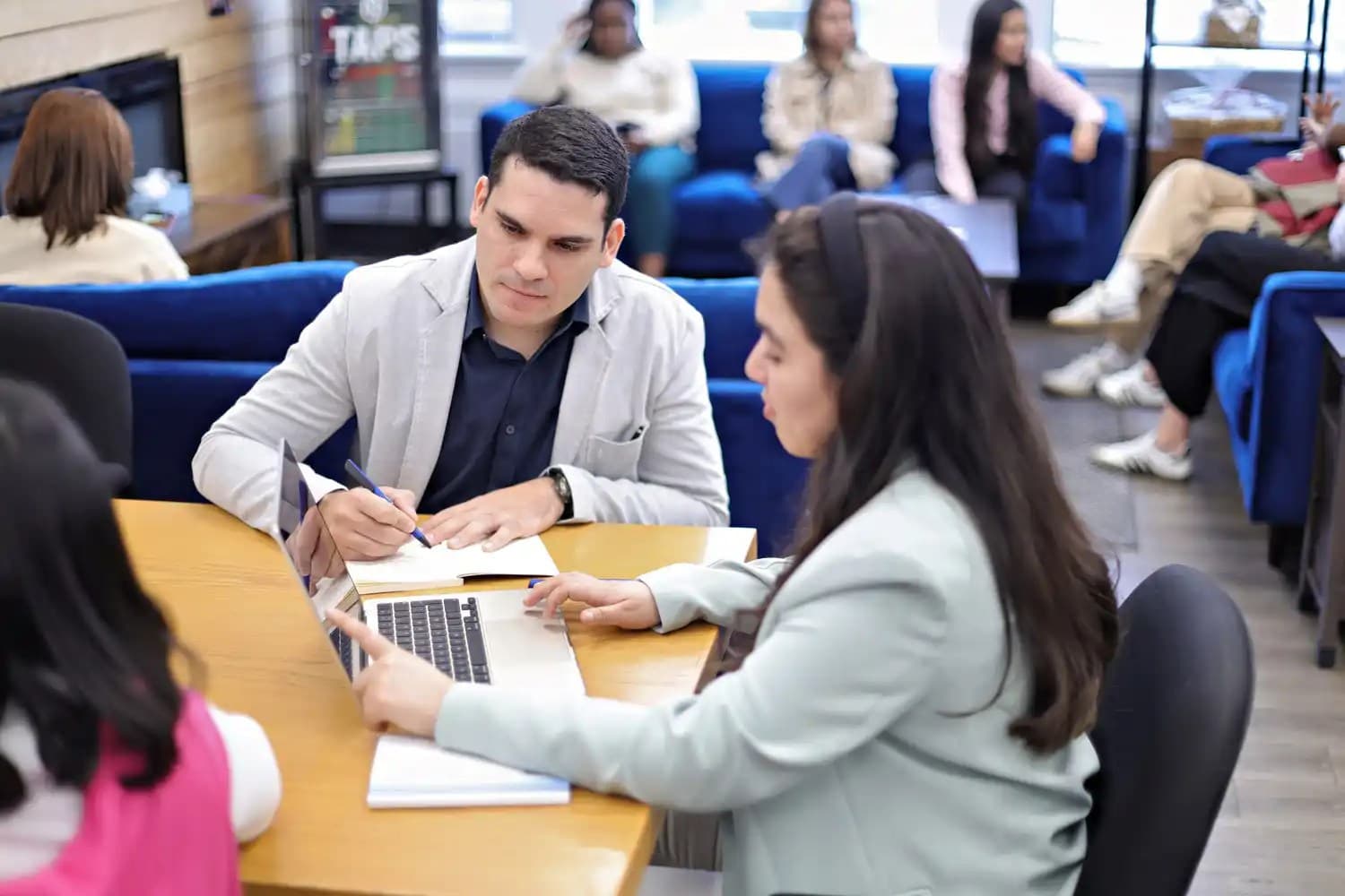 UNF students looking at a laptop screen