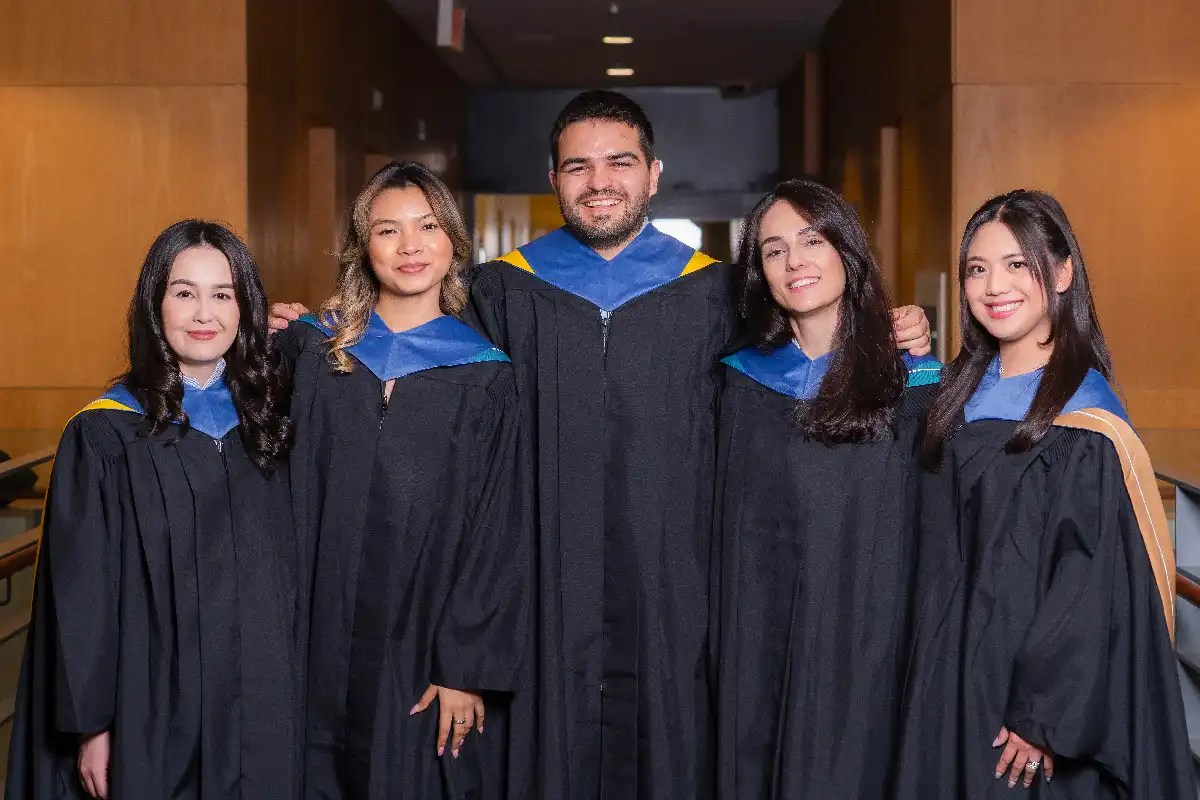 A group of graduates posing with the academic regalia