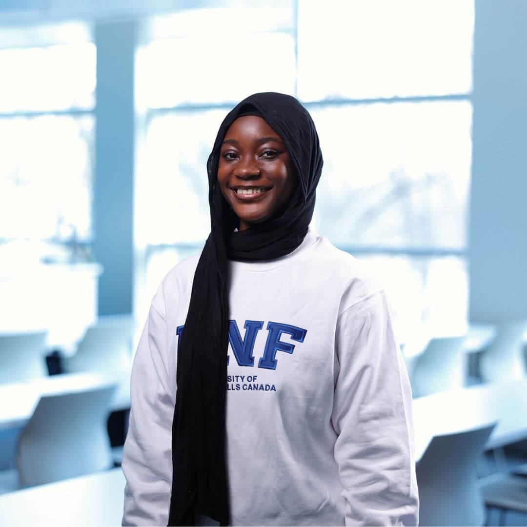 A portrait Fathia Oluwadamilola Ibrahim smiling for the camera