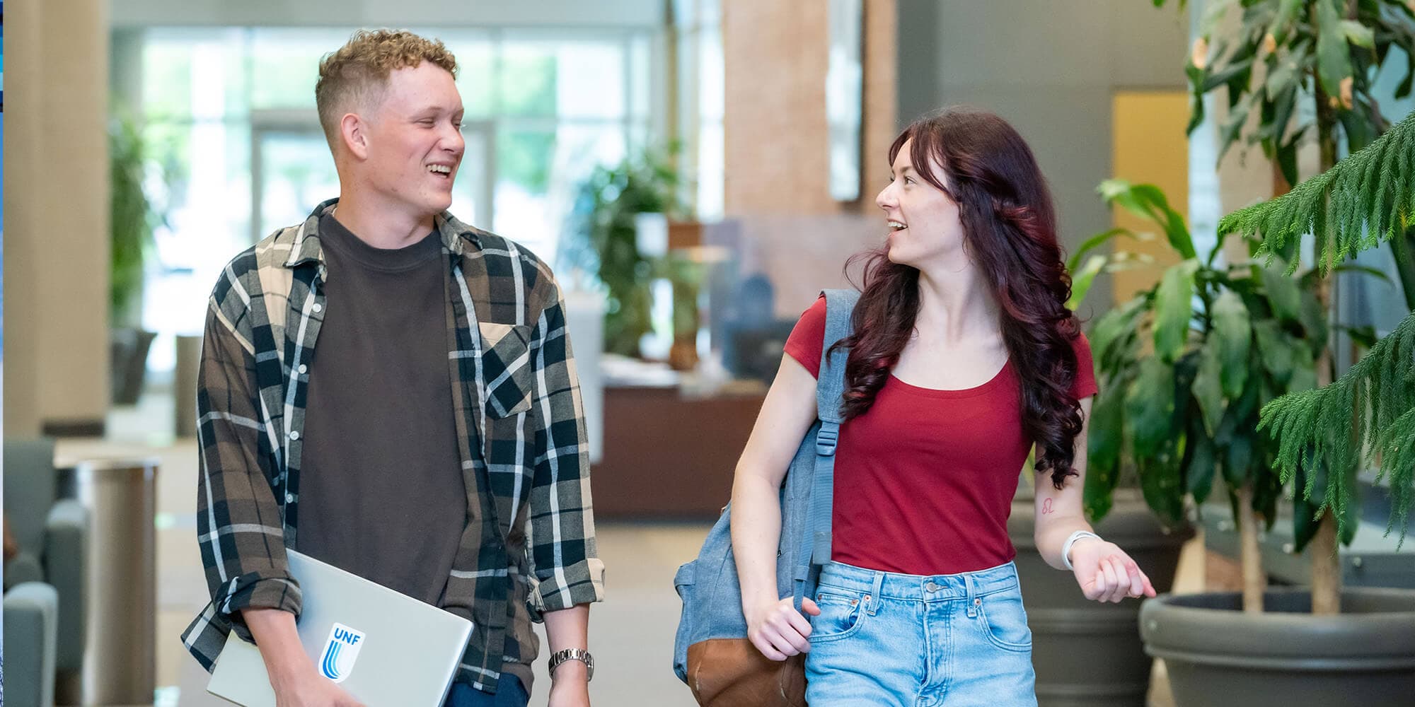 two students walking in UNF lobby