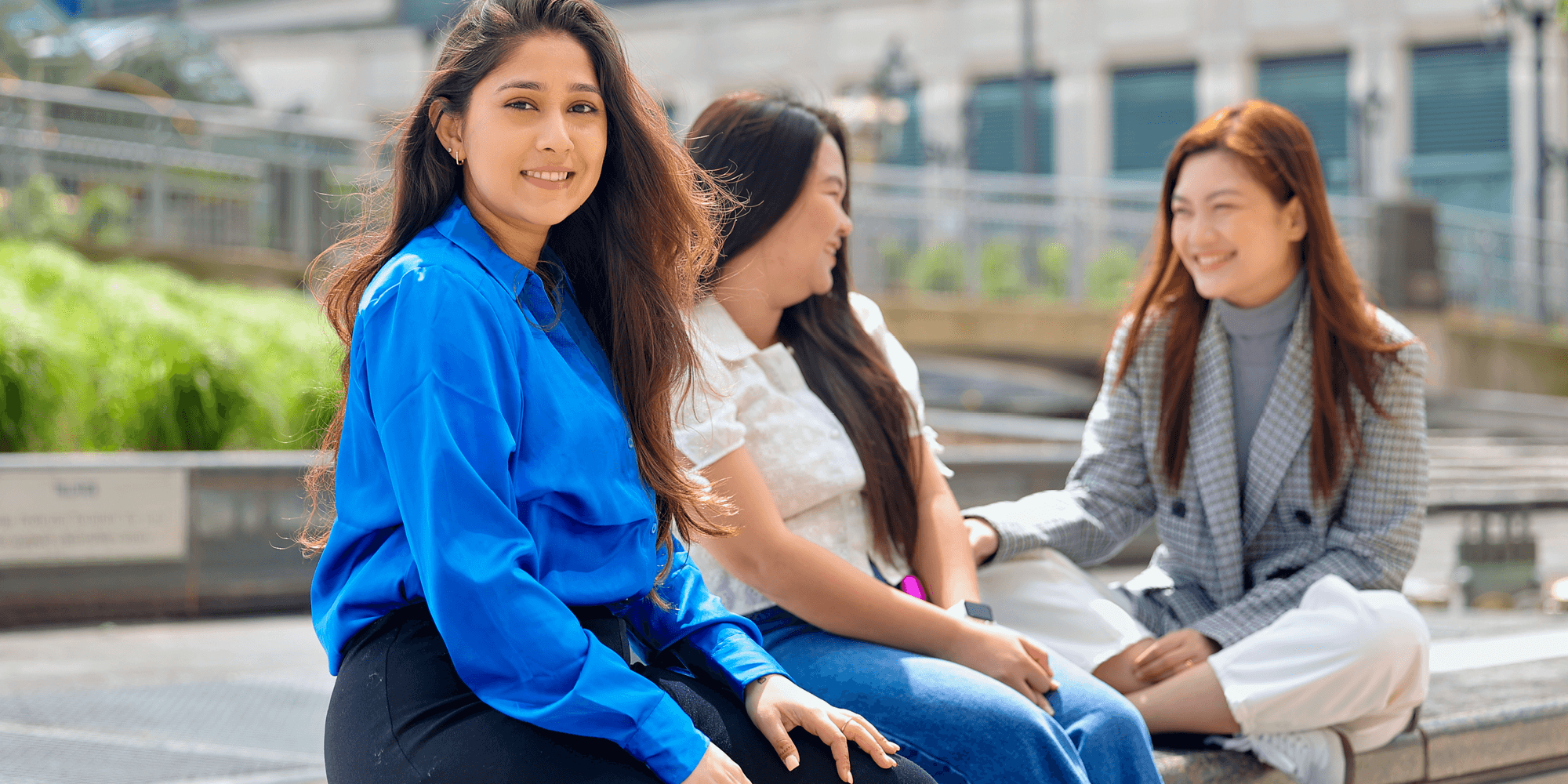 two female students talking outside the UNF campus and 1 female looking at the camera