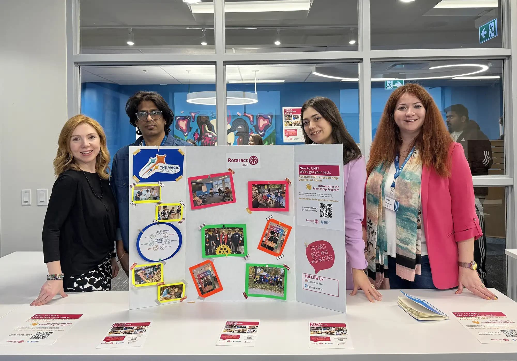 UNF students from Rotaract UNF club holding a presentation board