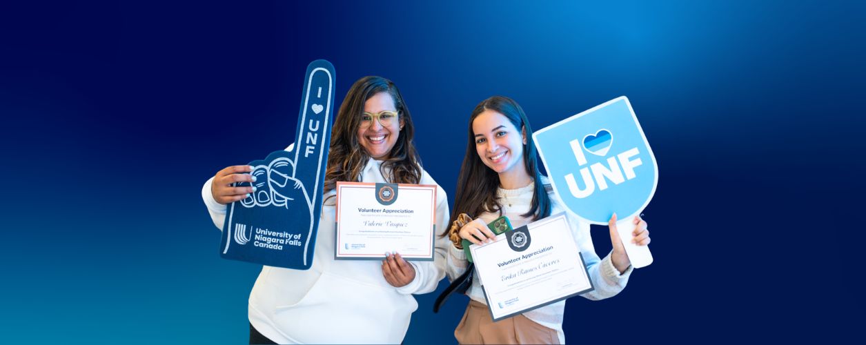 UNF student volunteers holding photo props