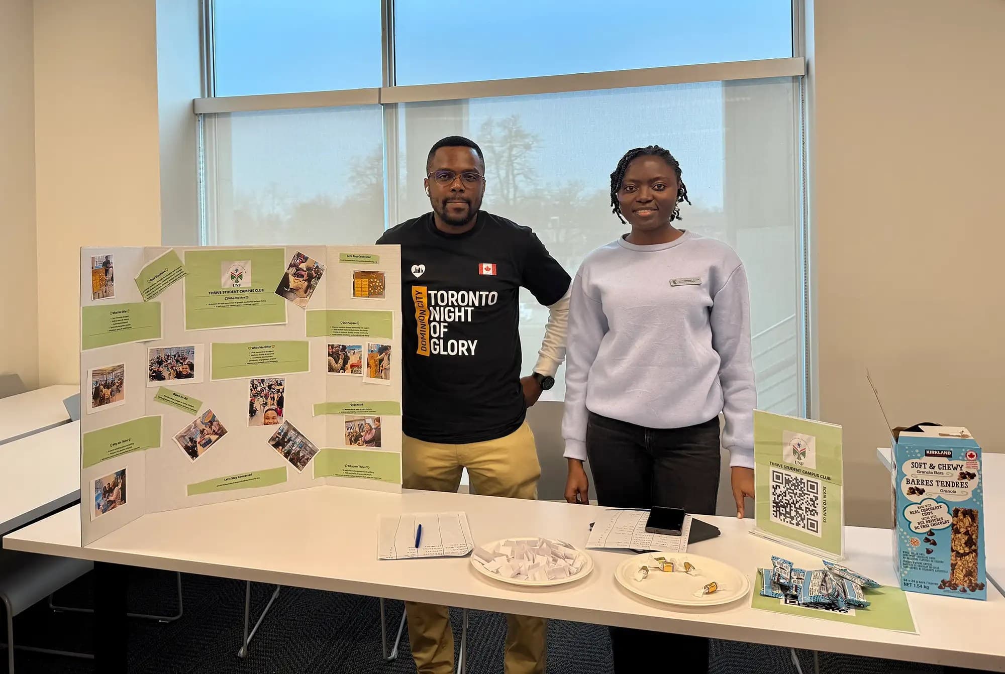 UNF students from Thrive Student Campus Club holding a presentation board