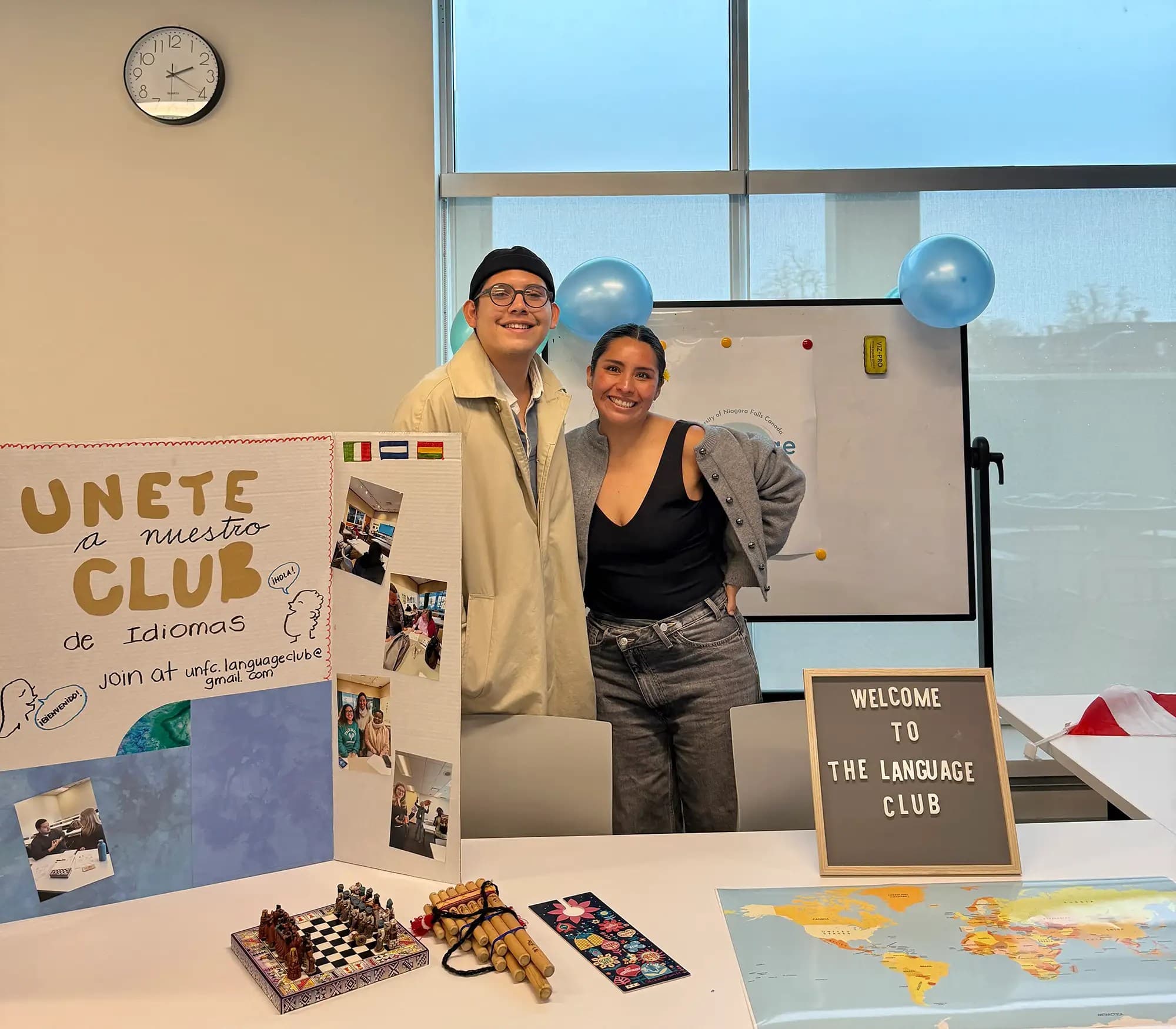 UNF students from UNF Language Club holding a presentation board