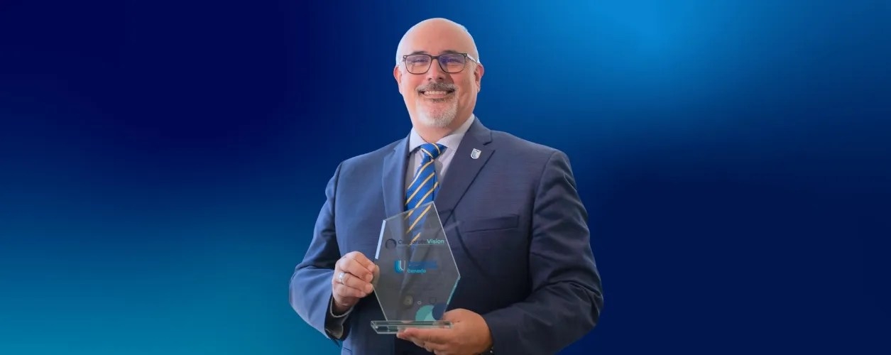 David Gray holding the award for Most Innovative Higher Education Institution 2025