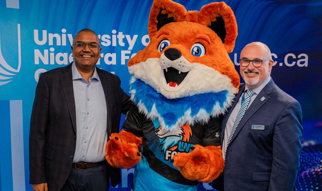 Spark posing for a picture with a UNF staff